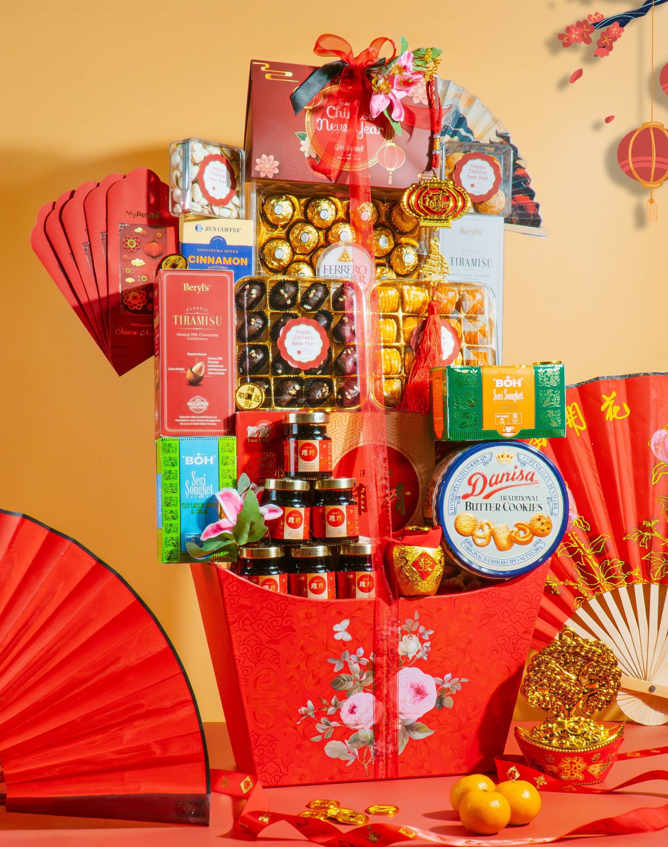 Chinese New Year gift 2026 hamper with cny snacks and decorative items on a peach background
