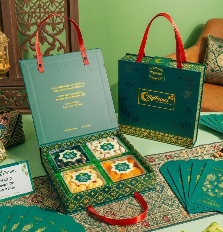 Gift set with green boxes, cards, and decorative items on a table with a green background.