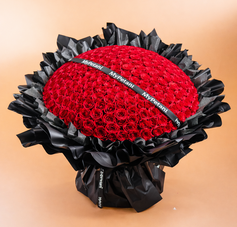 Red rose ball with black decorative paper on a beige background