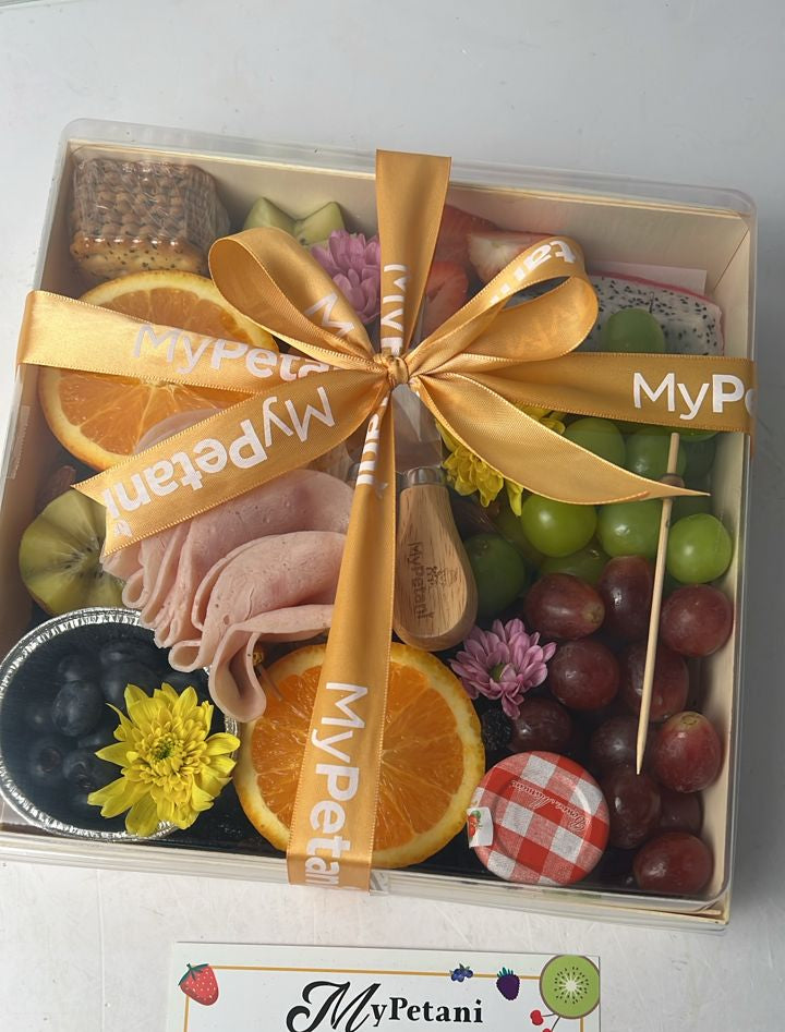 Gift box with fruits, cookies, and a spoon with 'MyPetani' branding on a white background.